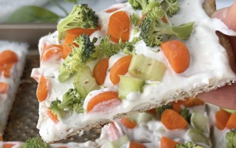 Sliced flatbread pizza with cheese, brocolli and carrots